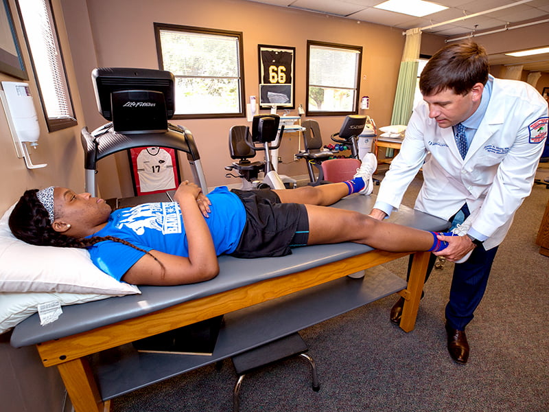 Montoria Atkinson, a Tougaloo College basketball player, receives treatment from Dr. Jim Hurt following a left knee ACL reconstruction with medial and lateral meniscus repair.